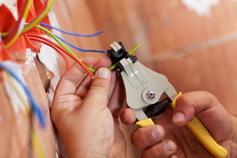 A technician installing a fire alarm system.