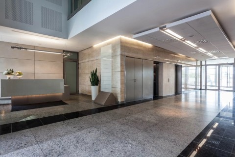 Commercial building lobby using door alarm system to manage access and security. 