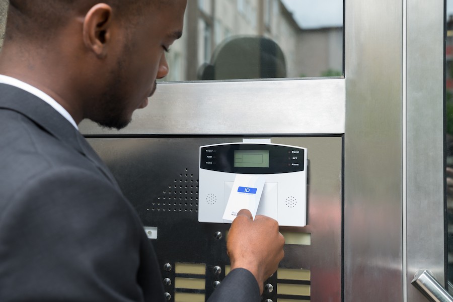 A man gaining access to a business via ID card. 